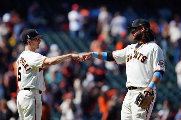 Mike Yastrzemski of the San Francisco Giants and Brandon Crawford celebrate after the game between the Philadelphia Phillies and the San Francisco...