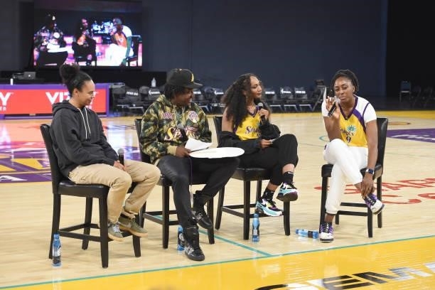 Kristi Toliver and Nneka Ogwumike of the Los Angeles Sparks talk with sports journalist Ari Chambers and DJ Mal-Ski after the game against the New...