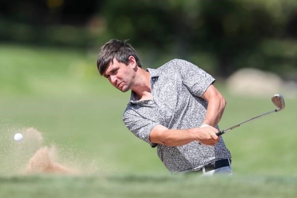 Ollie Schniederjans plays his shot out of the bunker on the 18th hole during the final round of the Wichita Open Benefitting KU Wichita Pediatrics at...