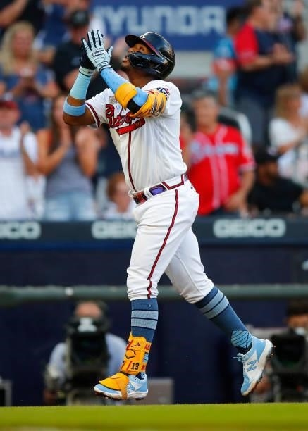 Ronald Acuna Jr. #13 of the Atlanta Braves reacts after hitting his 100th career home run in the third inning of game two of a doubleheader against...