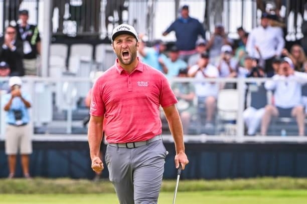 Jon Rahm of Spain celebrates with a fist pump after making a birdie putt on the 18th hole green during the final round of the 121st U.S. Open on the...