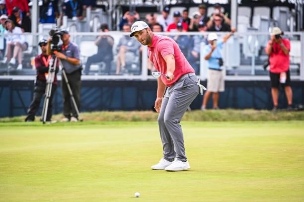 Jon Rahm of Spain raises his putter and celebrates after making a birdie putt on the 18th hole green during the final round of the 121st U.S. Open on...