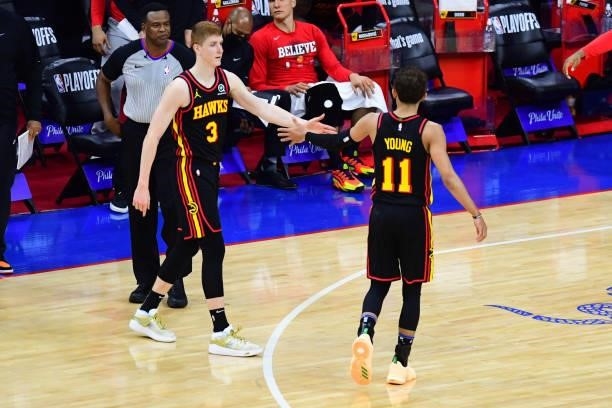 Kevin Huerter of the Atlanta Hawks high fives Trae Young of the Atlanta Hawks during Round 2, Game 7 of the 2021 NBA Playoffs on June 20, 2021 at...