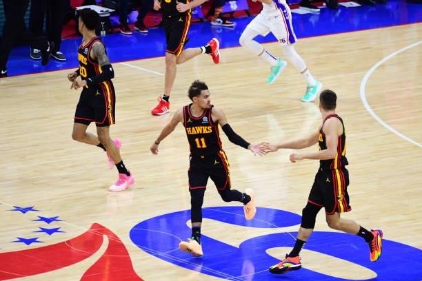 Trae Young of the Atlanta Hawks high fives Bogdan Bogdanovic of the Atlanta Hawks during Round 2, Game 7 of the 2021 NBA Playoffs on June 20, 2021 at...