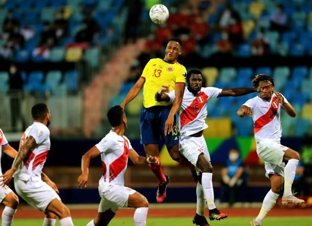 Yerry Mina of Colombia heads the ball against Christian Ramos of Peru during the match between Colombia and Peru as part of Conmebol Copa America...