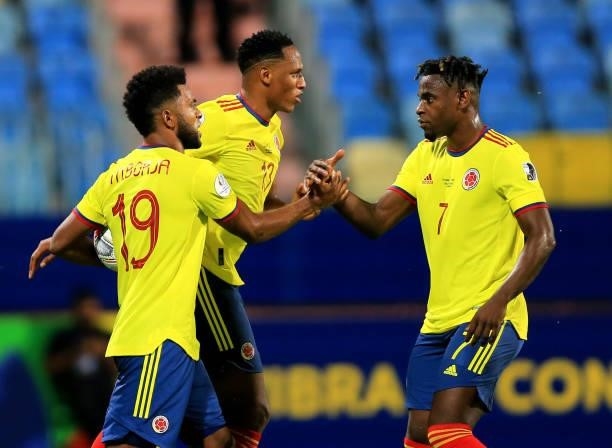 Miguel Borja of Colombia celebrates with his teammates Duvan Zapata and Yerry Mina after scoring a penalty during the match between Colombia and Peru...