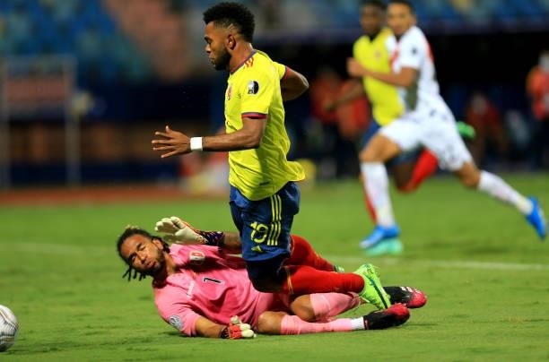 Pedro Gallese of Peru commits a foul on Miguel Borja of Colombia in the penalty box during the match between Colombia and Peru as part of Conmebol...