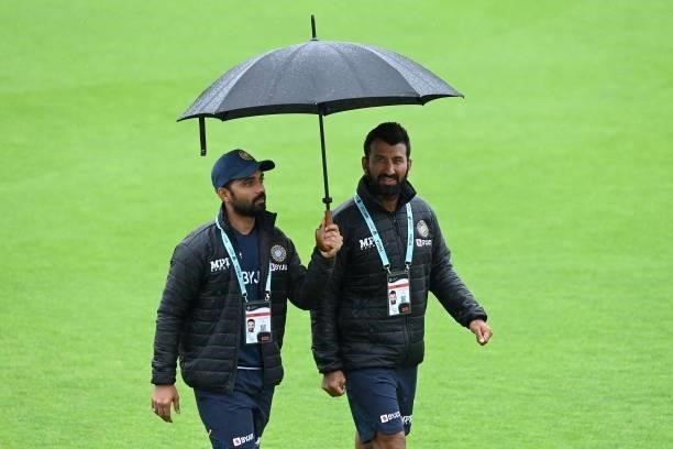 India's Ajinkya Rahane and India's Cheteshwar Pujara walk on the pitch as rain stops play on the fourth day of the ICC World Test Championship Final...