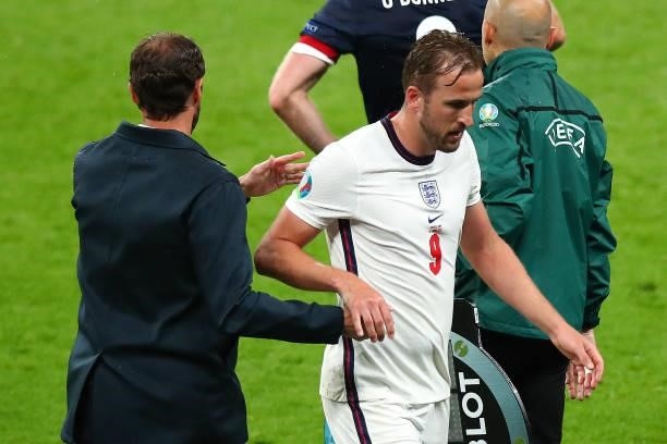 Dejected Harry Kane of England shakes hands with Gareth Southgate the head coach / manager of England as he is substituted off during the UEFA Euro...