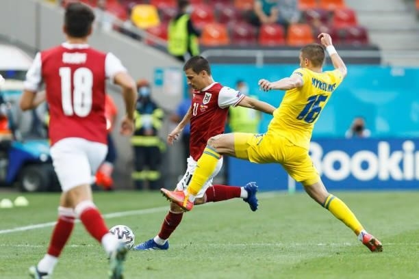 Stefan Lainer of Austria and Vitaliy Mykolenko of Ukraine battle for the ball after the UEFA Euro 2020 Championship Group C match between Ukraine and...