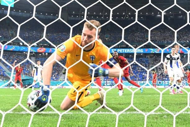 Finland's goalkeeper Lucas Hradecky concedes a goal during the UEFA EURO 2020 Group B football match between Finland and Belgium at Saint Petersburg...