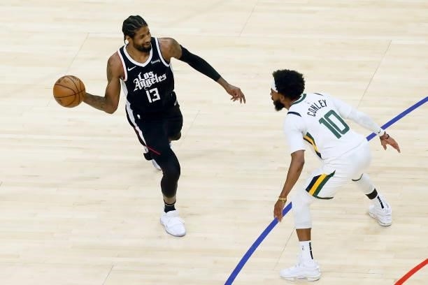Mike Conley of the Utah Jazz plays defense on Paul George of the LA Clippers during Round 2, Game 6 of the 2021 NBA Playoffs on June 18, 2021 at...