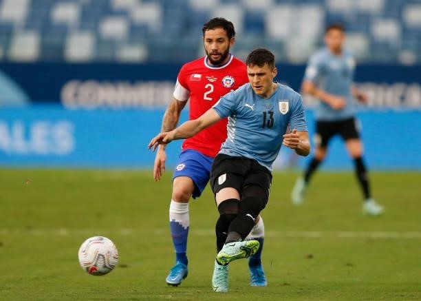 Giovanni Gonzalez of Uruguay competes for the ball with Eugenio Mena of Chile during the match between Uruguay and Chile as part of Conmebol Copa...