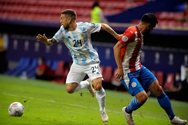 Alejandro Papu Gomez of Argentina competes for the ball with Alberto Espinola of Paraguay during the match between Argentina and Paraguay at Mane...