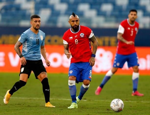 Arturo Vidal of Chile competes for the ball with Giorgian De Arrascaeta of Uruguay during the match between Uruguay and Chile as part of Conmebol...