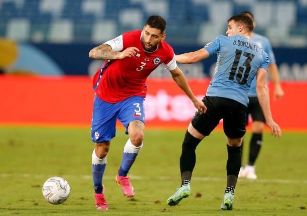 Guillermo Maripan of Chile competes for the ball with Giovanni Gonzalez of Uruguay during the match between Uruguay and Chile as part of Conmebol...