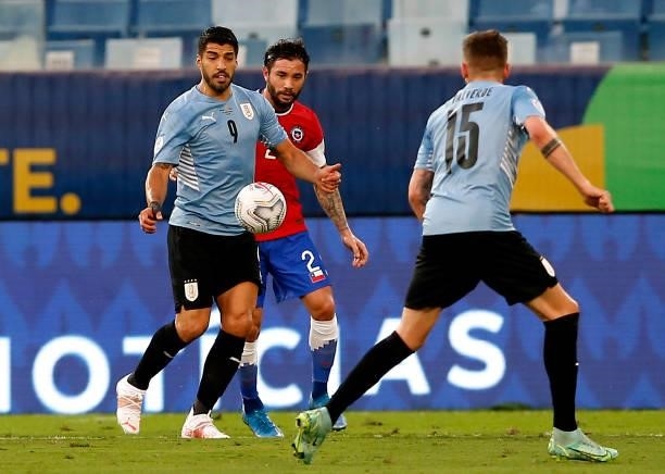 Luis Suarez of Uruguay competes for the ball with Eugenio Mena of Chile during the match between Uruguay and Chile as part of Conmebol Copa America...