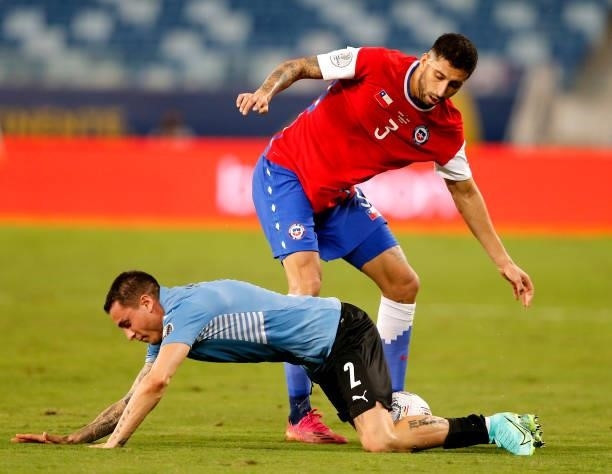Guillermo Maripan of Chile competes for the ball with Jose Gimenez of Uruguay during the match between Uruguay and Chile as part of Conmebol Copa...
