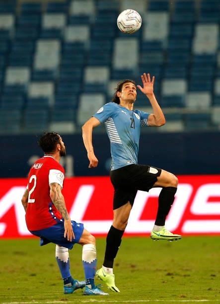 Edinson Cavani of Uruguay head the ball against Eugenio Mena of Chile during the match between Uruguay and Chile as part of Conmebol Copa America...