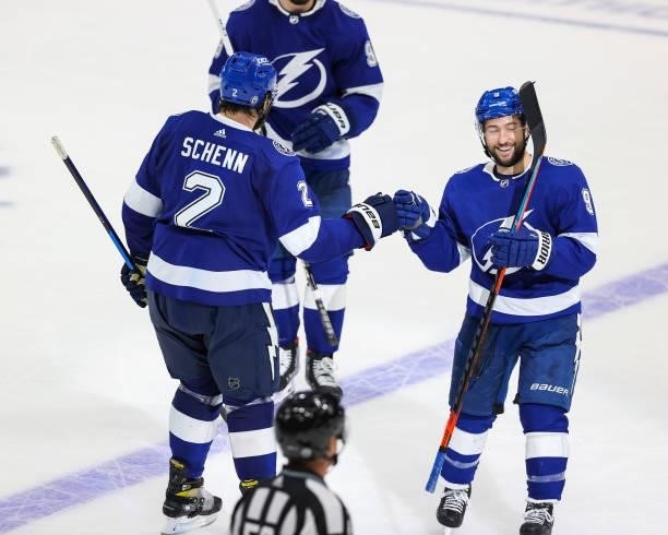 Luke Schenn of the Tampa Bay Lightning celebrates his goal with teammate Tyler Johnson against the New York Islanders in Game Five of the Stanley Cup...
