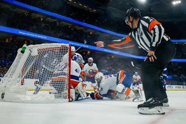 The puck deflects off Alex Killorn of the Tampa Bay Lightning and into the net for a goal against Semyon Varlamov of the New York Islanders in Game...