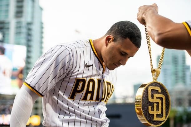 The 'swag chain' is placed on Manny Machado of the San Diego Padres after Machado's home run in the first inning against the Los Angeles Dodgers on...