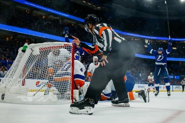 The puck deflects off Alex Killorn of the Tampa Bay Lightning and into the net for a goal against Semyon Varlamov of the New York Islanders in Game...