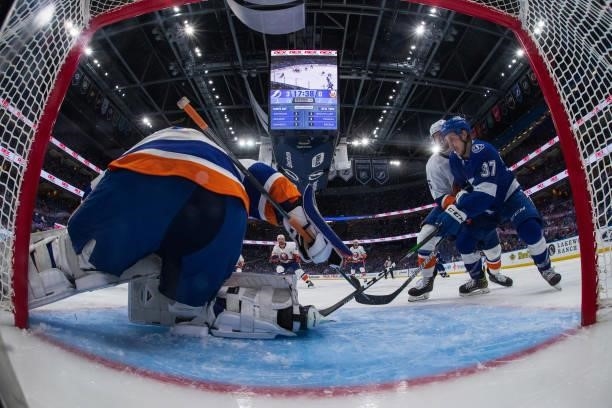 Goalie Ilya Sorokin of the New York Islanders makes a save against Yanni Gourde of the Tampa Bay Lightning in Game Five of the Stanley Cup Semifinals...