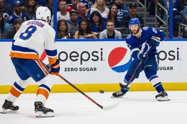 Brayden Point of the Tampa Bay Lightning passes the puck against Noah Dobson of the New York Islanders during the third period in Game Five of the...