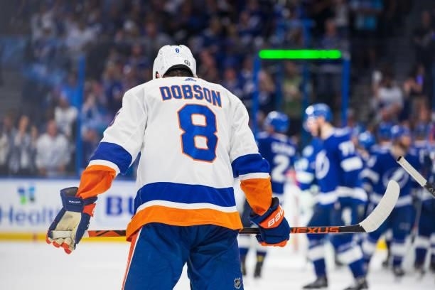 The Tampa Bay Lightning celebrate the win against Noah Dobson and the New York Islanders in Game Five of the Stanley Cup Semifinals of the 2021...