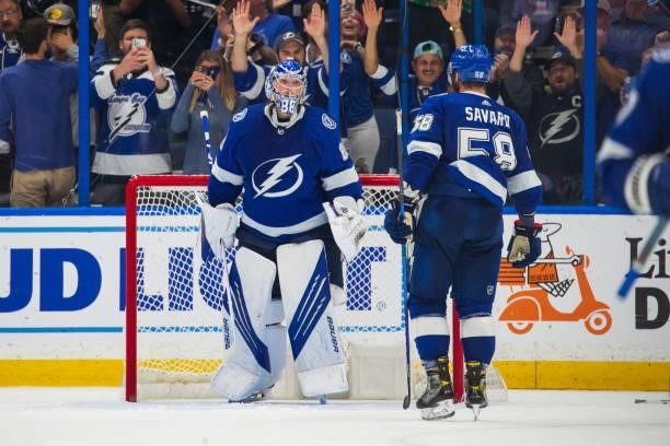 Goalie Andrei Vasilevskiy of the Tampa Bay Lightning celebrates the win with teammate David Savard against the New York Islanders in Game Five of the...