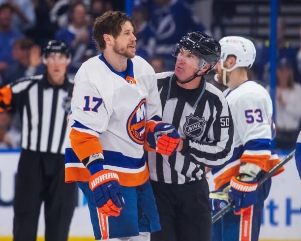 Matt Martin of the New York Islanders is escorted by linesman Scott Cherrey during the third period against the Tampa Bay Lightning in Game Five of...