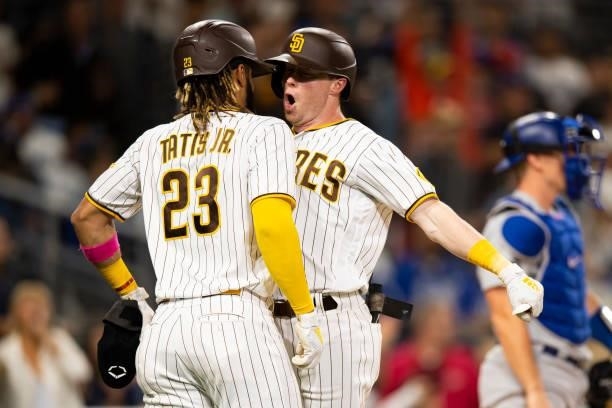 Jake Cronenworth of the San Diego Padres celebrates with Fernando Tatis Jr after hitting a home run in the fifth inning against the Los Angeles...