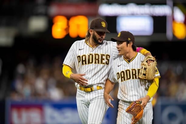 Fernando Tatis Jr and Ha-seong Kim of the San Diego Padres walks off the field against the Los Angeles Dodgers on June 21, 2021 at Petco Park in San...