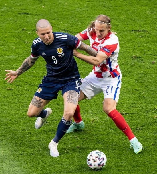 Scotland's Lyndon Dykes competes with Domagij Vida during a Euro 2020 match between Croatia and Scotland at Hampden Park, on June 22 in Glasgow,...