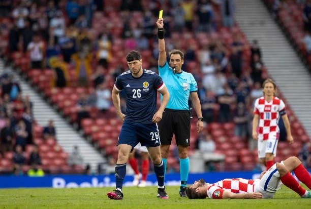 Scotland's Scott McKenna pick sup a yellow card for a foul on Bruno Petkovic during a Euro 2020 match between Croatia and Scotland at Hampden Park,...