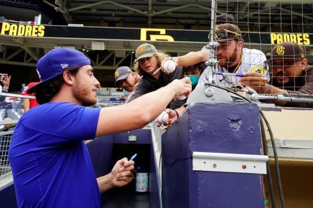 Cody Bellinger of the Los Angeles Dodgers signs autographs before the game between the Los Angeles Dodgers and the San Diego Padres at Petco Park on...