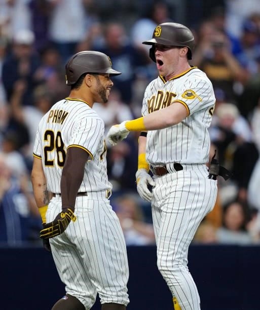 Jake Cronenworth of the San Diego Padres celebrates with Tommy Pham after after hitting a two home run during the game between the Los Angeles...