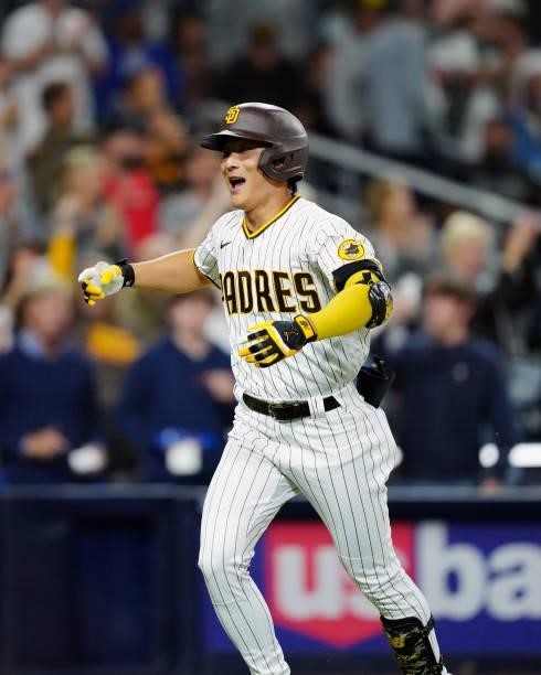 Ha-Seong Kim of the San Diego Padres reacts after hitting a home run during the game between the Los Angeles Dodgers and the San Diego Padres at...