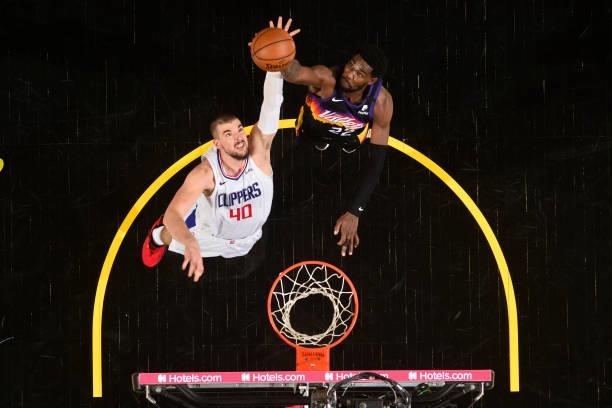 Ivica Zubac of the LA Clippers and Deandre Ayton of the Phoenix Suns reach for a rebound during Game 2 of the Western Conference Finals of the 2021...