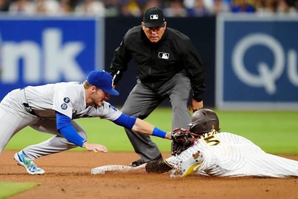 Gavin Lux of the Los Angeles Dodgers tags Wil Myers of the San Diego Padres at second base during the game at Petco Park on Tuesday, June 22, 2021 in...