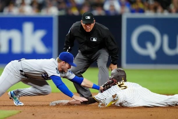 Gavin Lux of the Los Angeles Dodgers tags Wil Myers of the San Diego Padres at second base during the game at Petco Park on Tuesday, June 22, 2021 in...