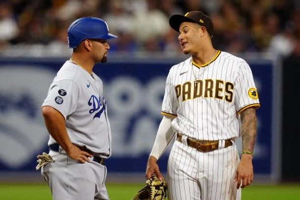 Manny Machado of the San Diego Padres and Albert Pujols of the Los Angeles Dodgers talk during the game at Petco Park on Tuesday, June 22, 2021 in...