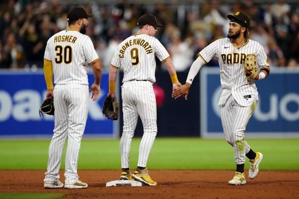 Fernando Tatis Jr. #23, Eric Hosmer and Jake Cronenworth of the San Diego Padres celebrate after the Padres defeated the Los Angeles Dodgers at Petco...