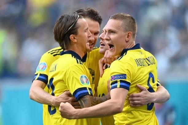 Sweden's players celebrate their first goal during the UEFA EURO 2020 Group E football match between Sweden and Poland at Saint Petersburg Stadium in...