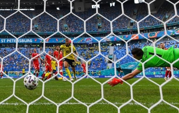 Poland's goalkeeper Wojciech Szczesny dives and concedes the opening goal scored by Sweden's midfielder Emil Forsberg during the UEFA EURO 2020 Group...