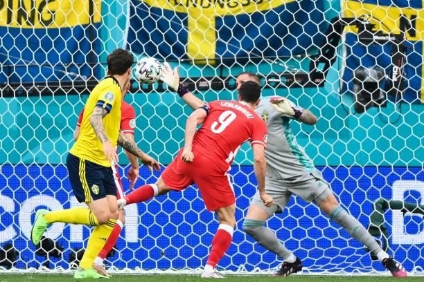 Poland's forward Robert Lewandowski heads the ball and misses a goal opportunity during the UEFA EURO 2020 Group E football match between Sweden and...