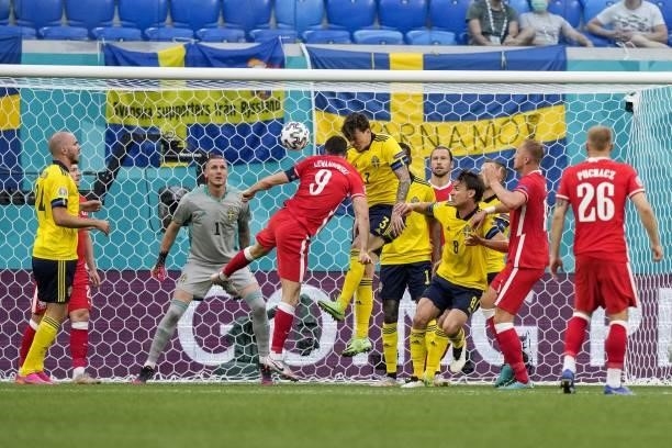 Poland's forward Robert Lewandowski jumps to head the ball during the UEFA EURO 2020 Group E football match between Sweden and Poland at Saint...