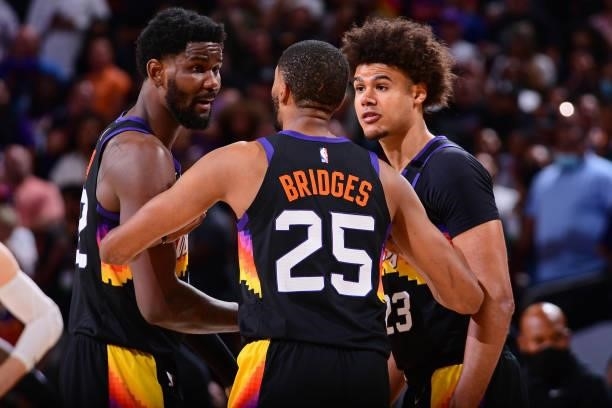 Cameron Johnson and Deandre Ayton of the Phoenix Suns talk to Mikal Bridges of the Phoenix Suns during Game 2 of the Western Conference Finals of the...