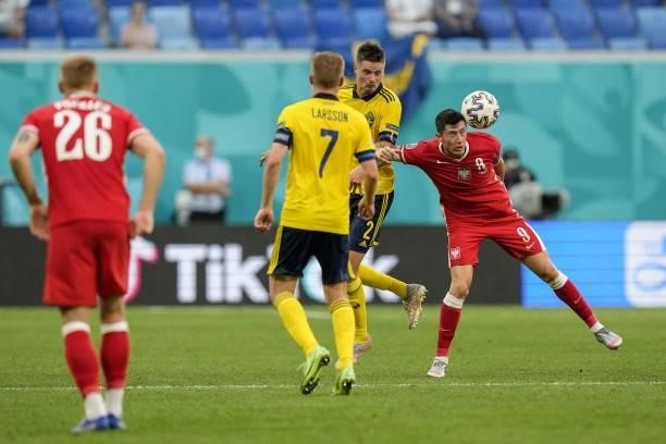 Poland's forward Robert Lewandowski fights for the ball with Sweden's defender Mikael Lustig during the UEFA EURO 2020 Group E football match between...